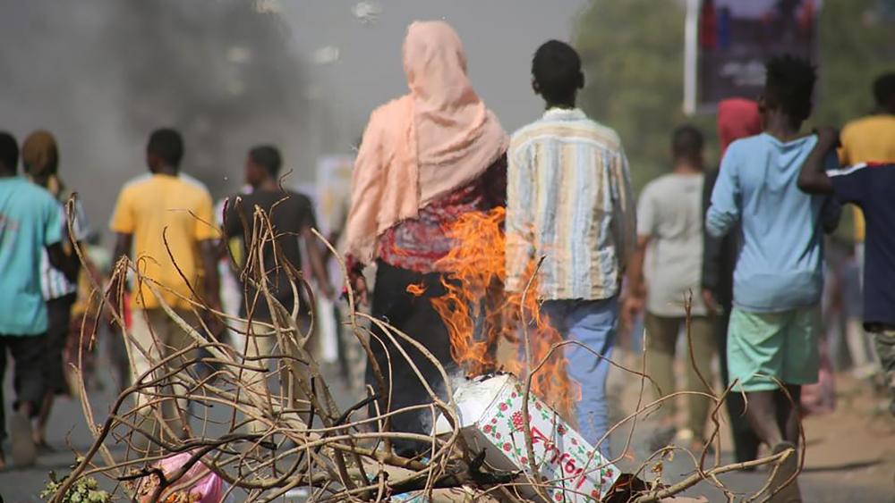 n this Monday Oct. 25, 2021 file photo, pro-democracy protesters use fires to block streets to condemn a takeover by military officials in Khartoum, Sudan. (AP Photo/Ashraf Idris, File )