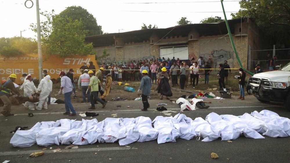 Bodies in bodybags are placed on the side of the road after an accident in Tuxtla Gutierrez, Chiapas state, Mexico, Thursday, Dec. 9, 2021.  (AP Photo)