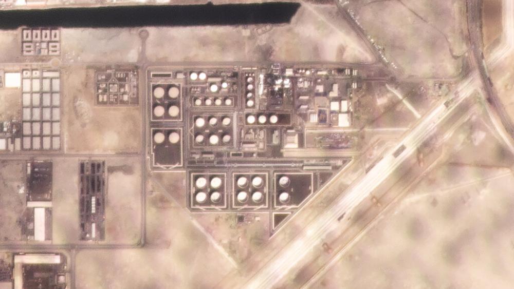 In this satellite image provided by Planet Labs PBC, white fire suppressing foam is seen after an attack on an Abu Dhabi National Oil Co. fuel depot. (Planet Labs PBC via AP)