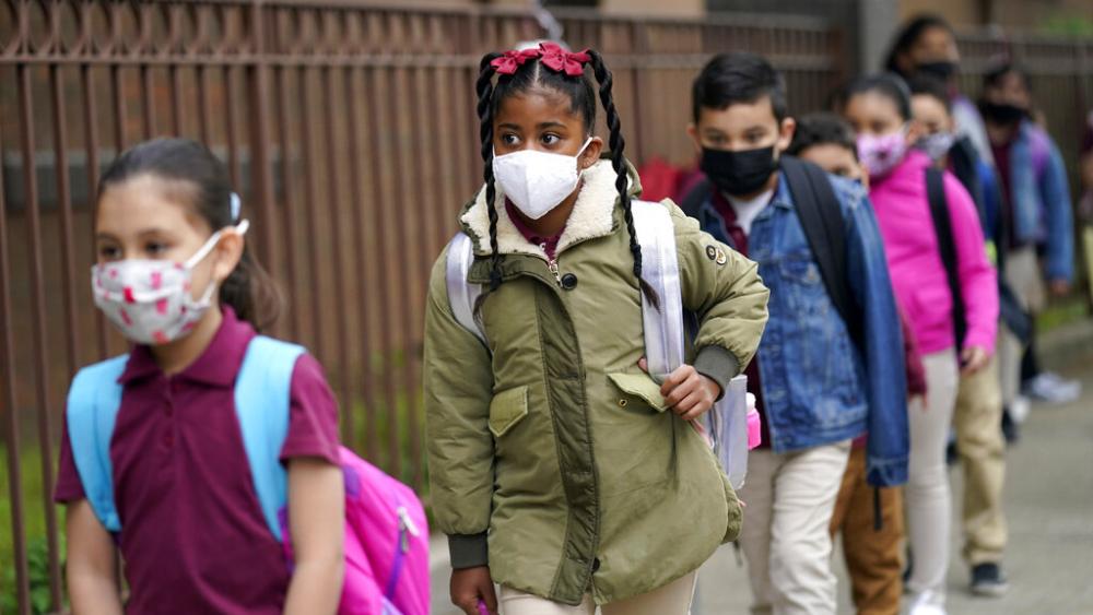 Students line up to enter Christa McAuliffe School in Jersey City, N.J., April 29, 2021. New Jersey Gov. Phil Murphy will end a statewide mask mandate to protect against COVID-19 in schools and child care centers, his office said Monday, Feb 7, 2022. (AP)