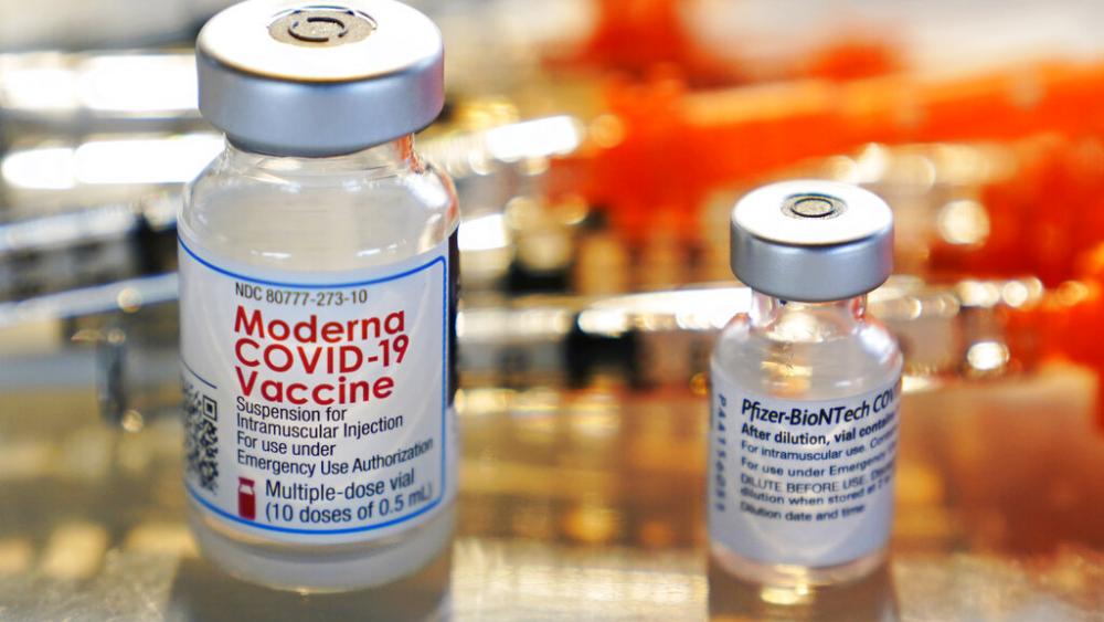 FILE - Vials for the Moderna and Pfizer COVID-19 vaccines are seen at a temporary clinic in Exeter, N.H. on Thursday, Feb. 25, 2021. (AP Photo/Charles Krupa, File)
