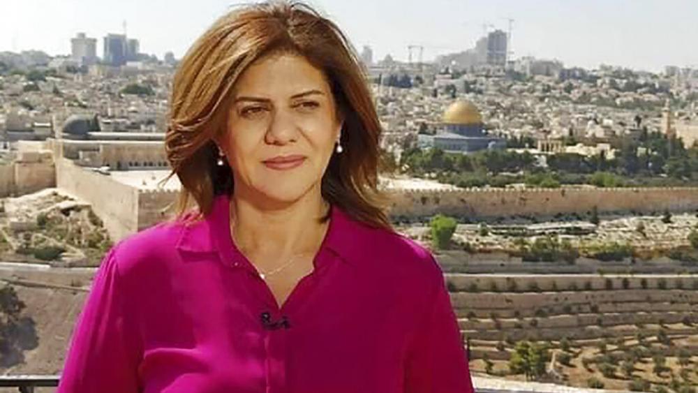 In this undated photo provided by Al Jazeera Media Network, Shireen Abu Akleh, a journalist for Al Jazeera network, stands in Jerusalem. (Al Jazeera Media Network via AP)