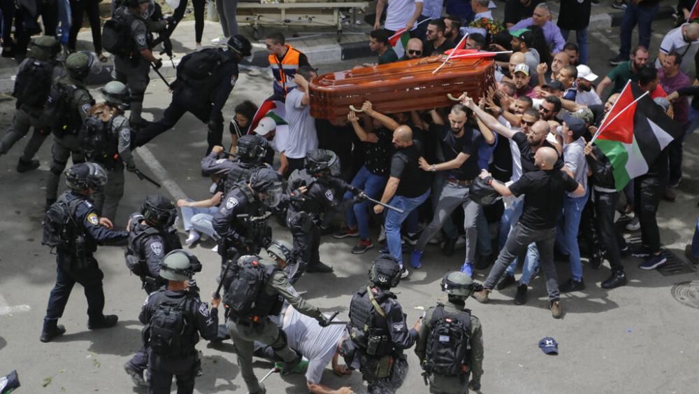 Israeli police confront mourners carrying the casket of slain Al Jazeera veteran journalist Shireen Abu Akleh during her funeral in Jerusalem, Friday, May 13, 2022. (AP Photo/Maya Levin, File)