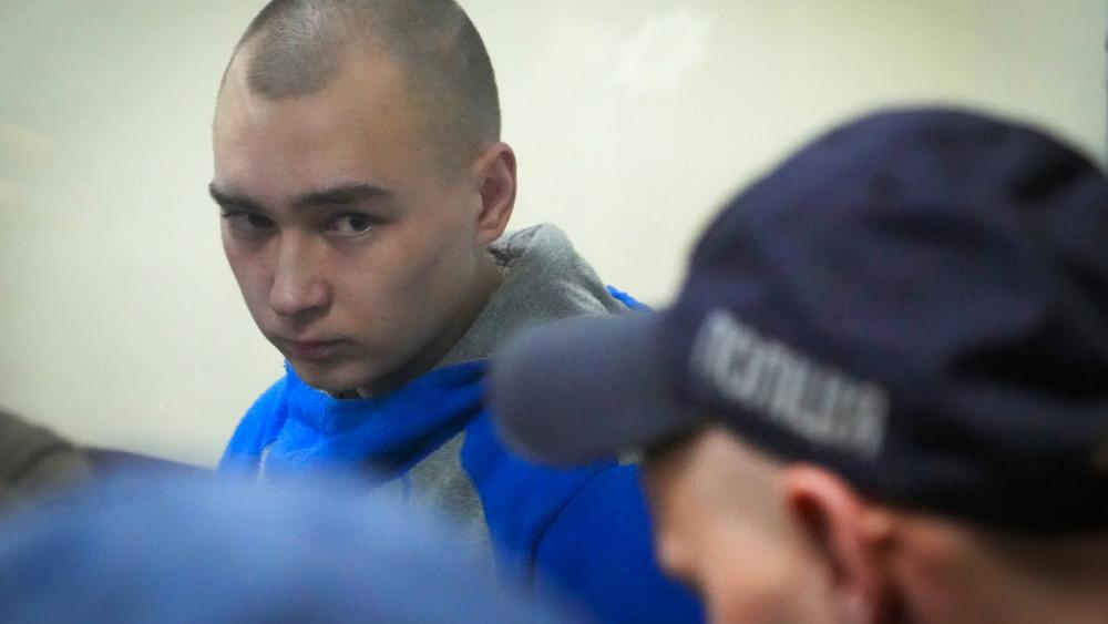 Russian army Sergeant Vadim Shishimarin, 21, is seen behind a glass during a court hearing in Kyiv, Ukraine, Wednesday, May 18, 2022. (AP Photo/Efrem Lukatsky)