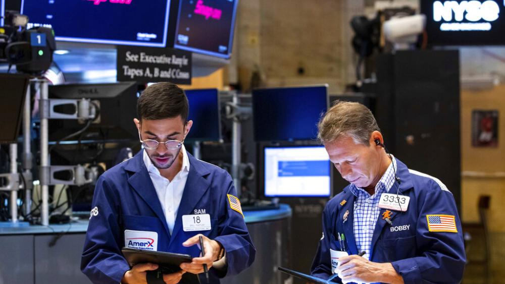 In this photo provided by the New York Stock Exchange, traders Orel Partush, left, and Robert Charmak work on the floor, Friday, June 10, 2022. (David L. Nemec/New York Stock Exchange via AP)