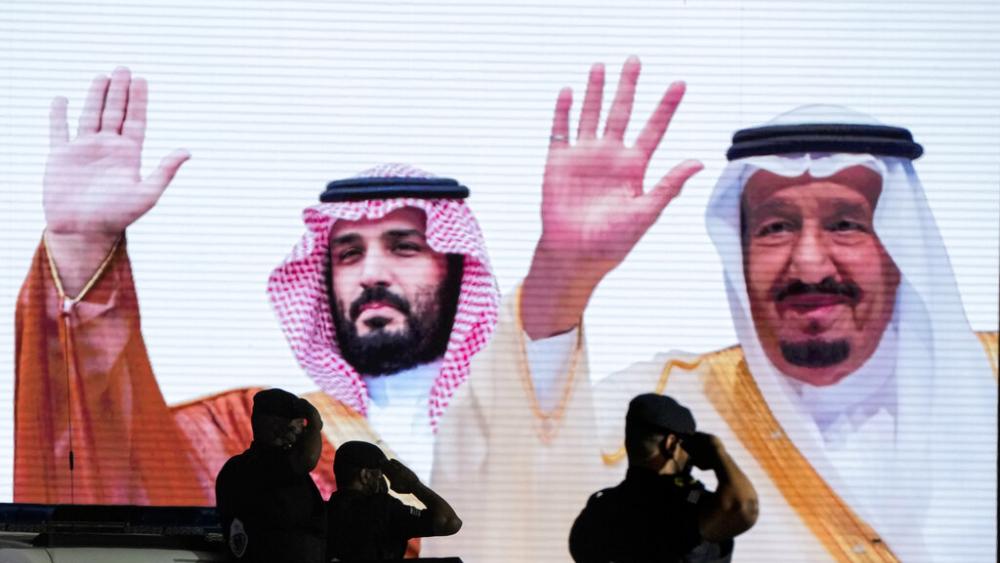  Saudi special forces salute in front of a screen displaying images Saudi King Salman, right, and Crown Prince Mohammed bin Salman.  (AP Photo/Amr Nabil, File)
