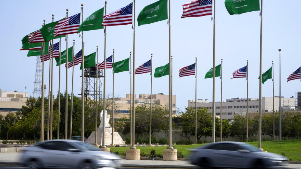 Vehicles drive past American and Saudi Arabian flags prior to a visit by U. S. President Joe Biden, at a square in Jeddah, Saudi Arabia, Thursday, July 14, 2022. (AP Photo/Amr Nabil)