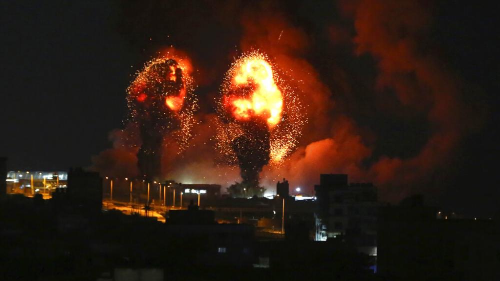 Sparks from an explosion caused by Israeli airstrikes in Gaza City, Saturday, July 16, 2022. (AP Photo/Mohammed Ali)