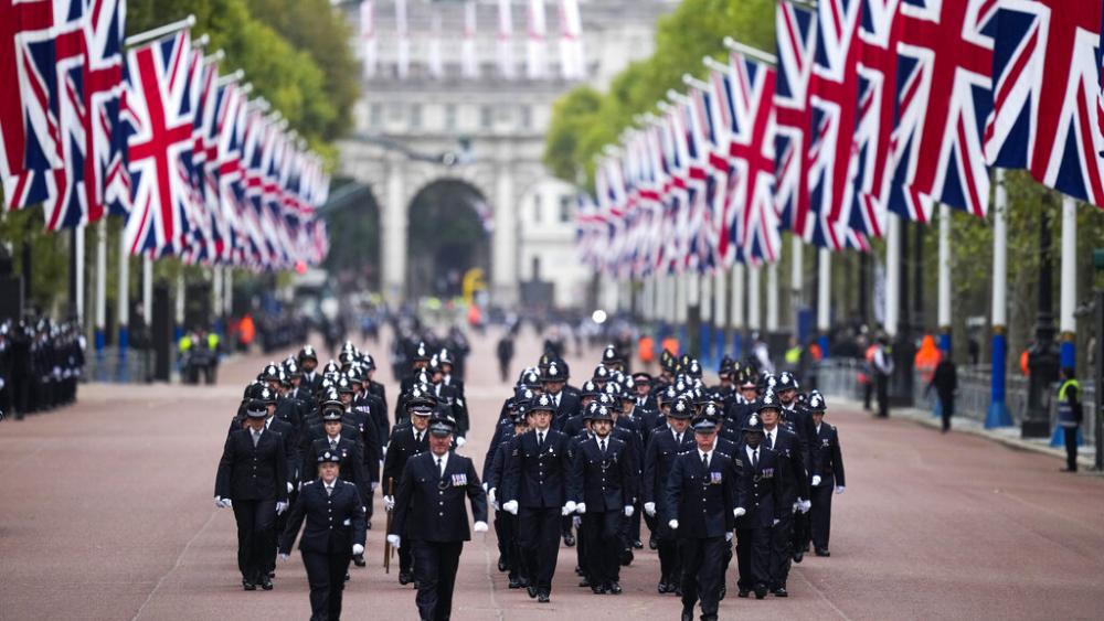 Police officers take positions ahead of the Queen Elizabeth II funeral in central London, Monday, Sept. 19, 2022. (AP Photo/Vadim Ghirda, Pool)