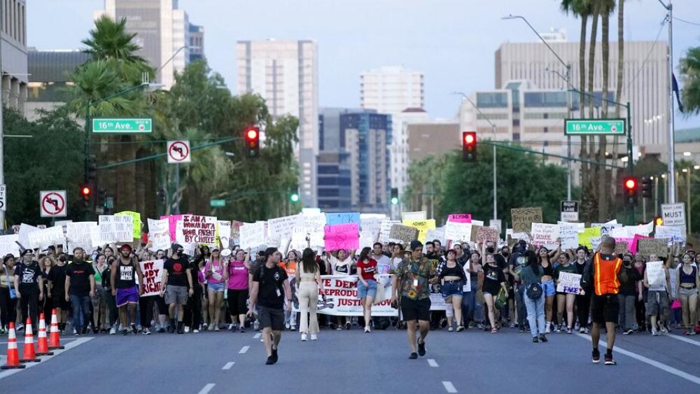 Thousands of protesters march around the Arizona Capitol after the Supreme Court overturned the landmark Roe v. Wade abortion decision (AP Photo/Ross D. Franklin)