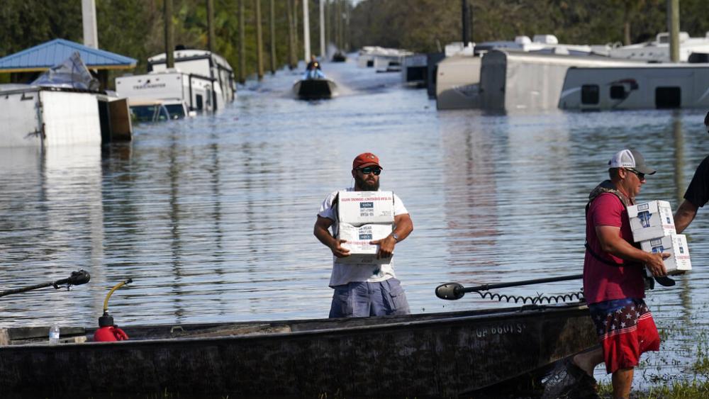 Meals, diapers, and water being delivered to flooded areas along the Peace River, in the aftermath of Hurricane Ian in Arcadia, Fla., Oct. 3, 2022. (AP Photo/Gerald Herbert)