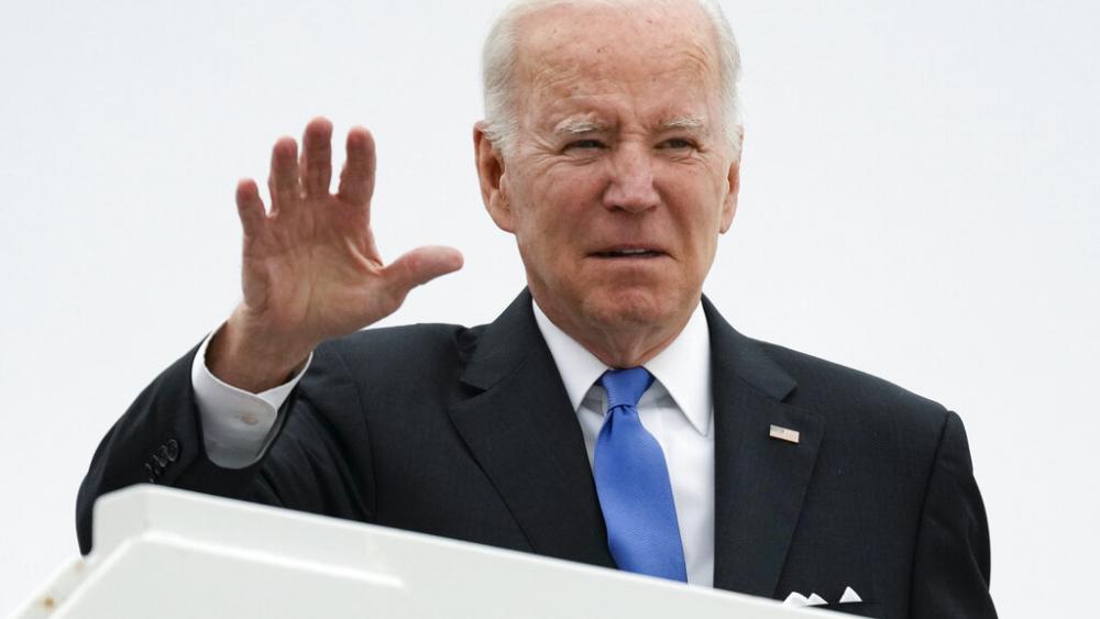 President Joe Biden waves before boarding Air Force One at Dover Air Force Base, in Dover, Del., on Monday, Jan. 23, 2023, en route to Washington. (AP Photo/Carolyn Kaster)