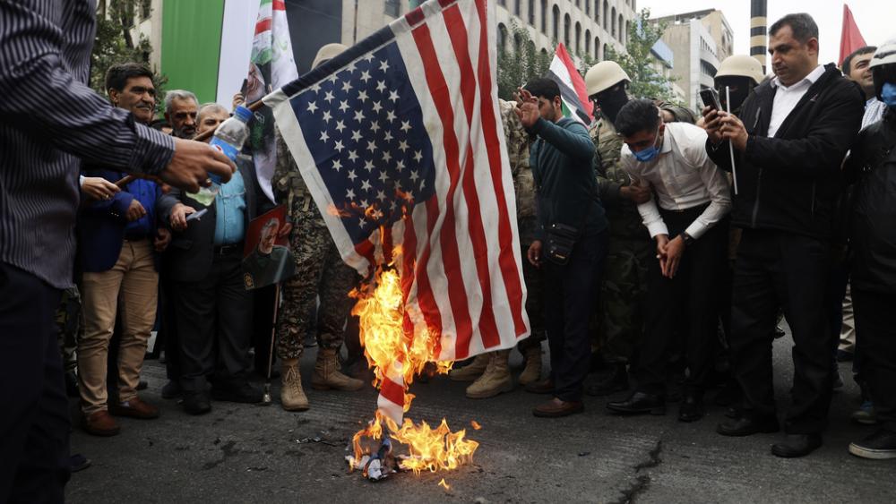 Iranian Muslims burn a U.S. flag during their pro-Palestinian rally in Tehran, Iran, Friday, Oct. 13, 2023. (AP Photo)