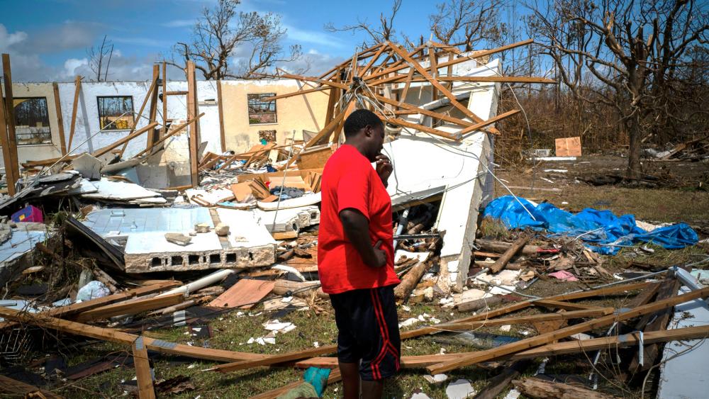 A man cries after discovering his shattered house, not knowing if his 8 relatives who lived there survived Hurricane Dorian on Grand Bahama island (AP Photo/Ramon Espinosa)