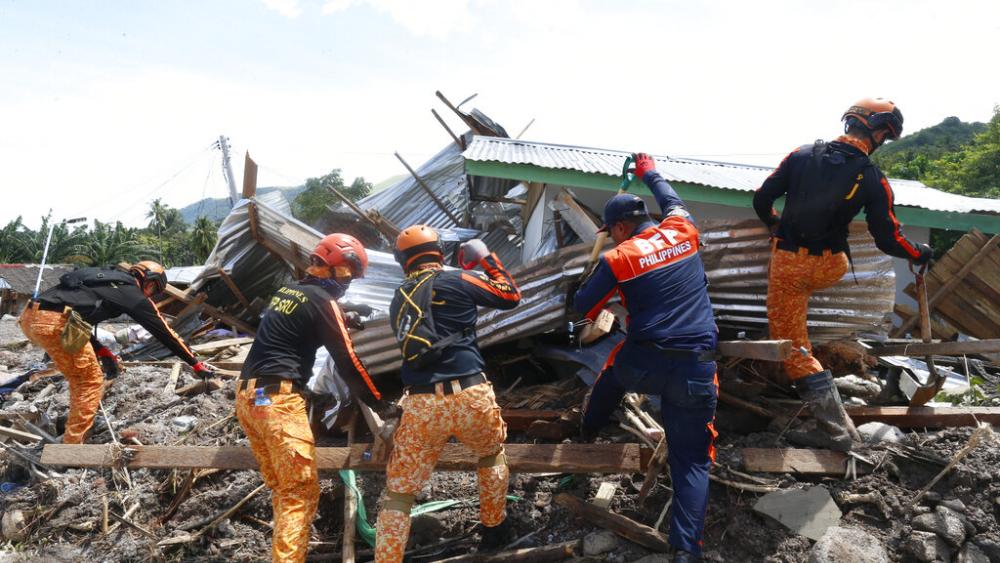 Rescuers search for bodies in southern Philippines after a huge mudslide set off by Tropical Storm Nalgae on Oct. 30, 2022. (AP Photo)