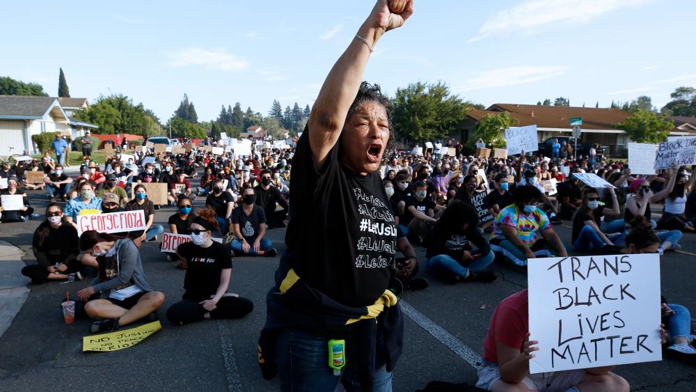 A protester shouts the name &quot;George Floyd!&quot; during a demonstration in Sacramento, Calif.  (AP Photo/Rich Pedroncelli)