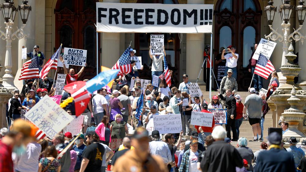 People protest at the State Capitol during a rally in Lansing, Mich., May 20, 2020. Barbers and hair stylists are protesting the state&#039;s stay-at-home orders as small businesses are eager to reopen (AP Photo/Paul Sancya)