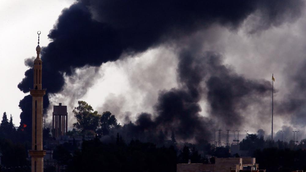 Smoke billows from targets inside Syria during bombardment by Turkish forces Thursday, Oct. 10, 2019. (AP Photo/Lefteris Pitarakis)