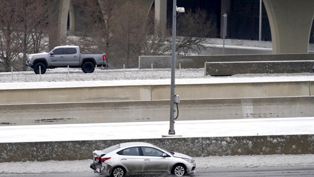 Drivers slowly navigate through icy road conditions on LBJ 635 Freeway, Tuesday, Jan. 31, 2023, in Dallas. (AP Photo/Tony Gutierrez)