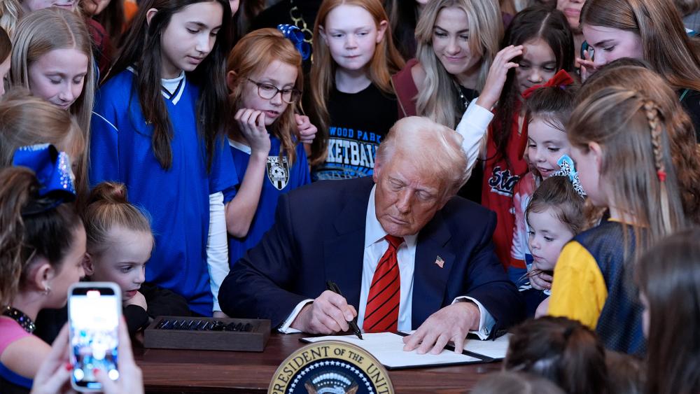 President Donald Trump signs an executive order barring transgender female athletes from competing in women&#039;s or girls&#039; sporting events, in the East Room of the White House, Wednesday, Feb. 5, 2025, in Washington. (AP Photo/Alex Brandon)