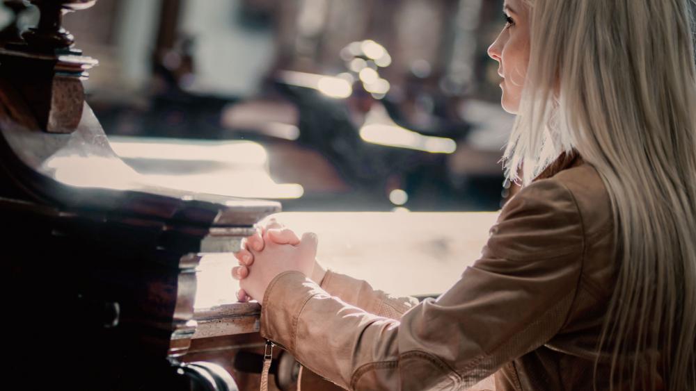Woman praying in church Woman praying in church
