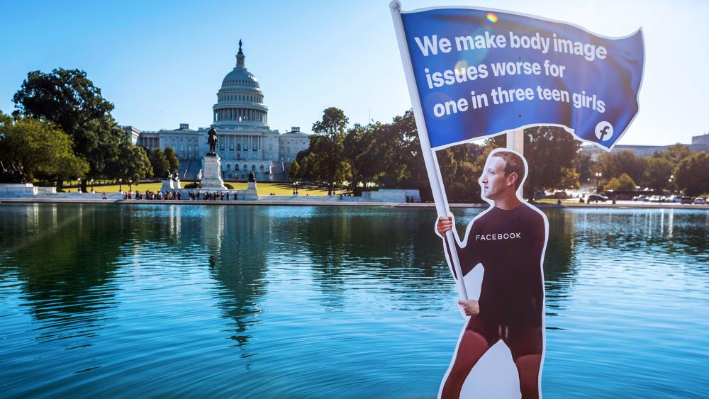 SumOfUs erected a seven-foot visual protest outside the US Capitol depicting Facebook CEO Mark Zuckerberg surfing as young women are hurt by his social media outlets (Eric Kayne/AP Images for SumofUS)